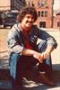  Chuck sitting on a curb outside his frat house at college.