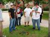  Chuck's Nephew Michael (Tan shorts) and other members of Chuck's Fraternity, Delta Tau, at Brown University, placing flowers at base of Memorial tree planted for Chuck and Frat brothers killed on 9-11.