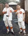 Acting cocky with his brother Mike after a victorious Little League baseball game  (1967)