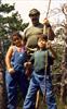 Chuck with his daughter Norma Jean, son Charlie & walking sticks on a hike in the mountains.