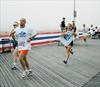  Sarah Margiotta pushing herself to the finish line of the Memorial Day race 2002.  Here she is seen holding Chuck's T-shirt.